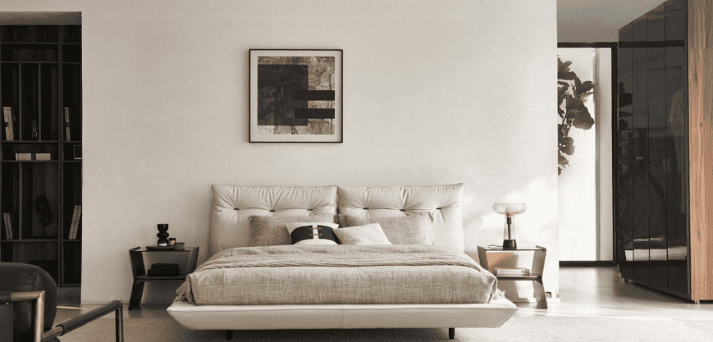 Modern bedroom with neutral tones, plush bed, and stylish decor from The Home Emporium.