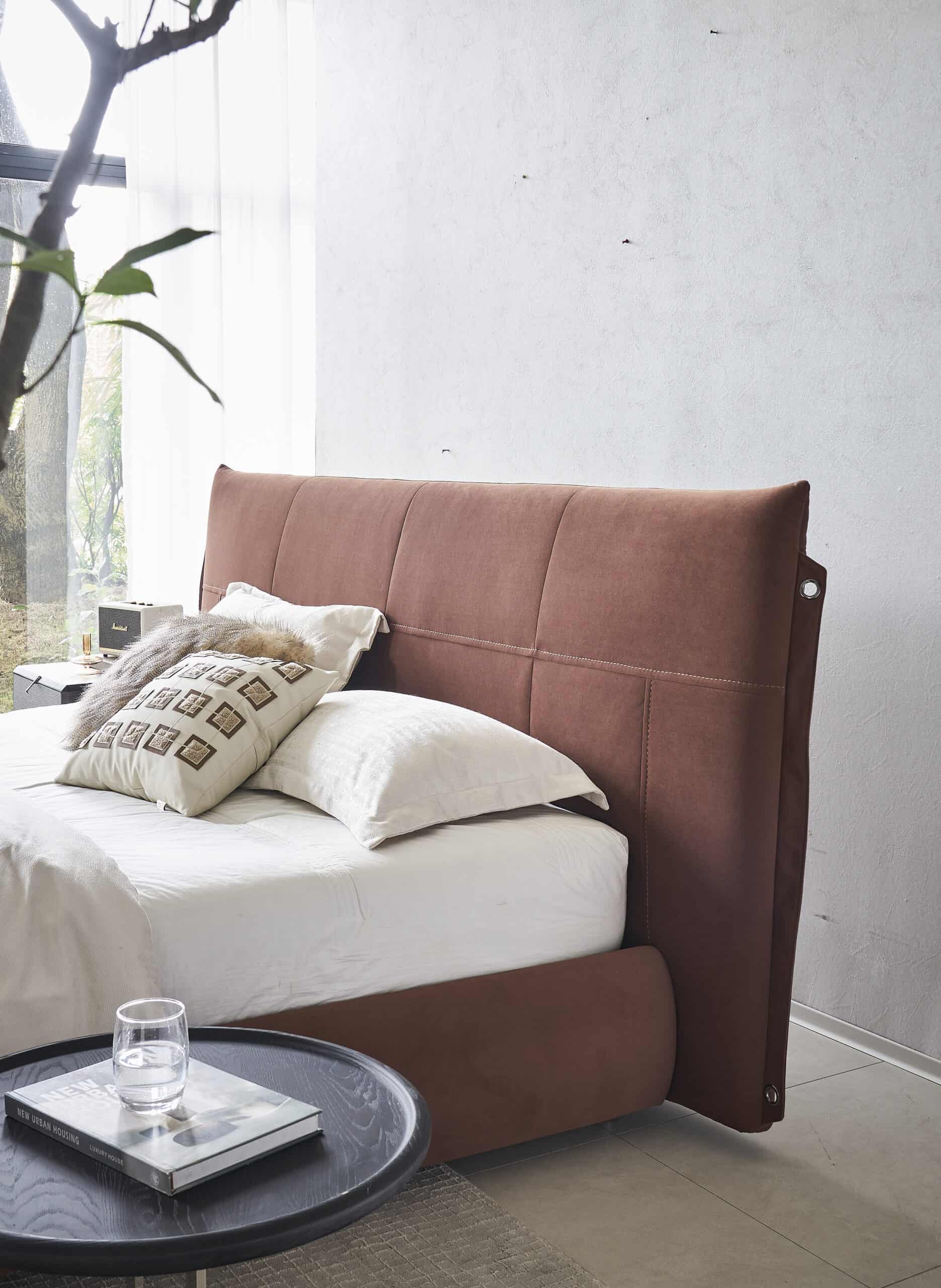 Organic modern bedroom with blush upholstered headboard and neutral bedding.