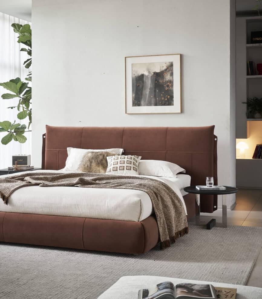 Modern organic bedroom with rust-colored upholstered bed and minimalist decor.