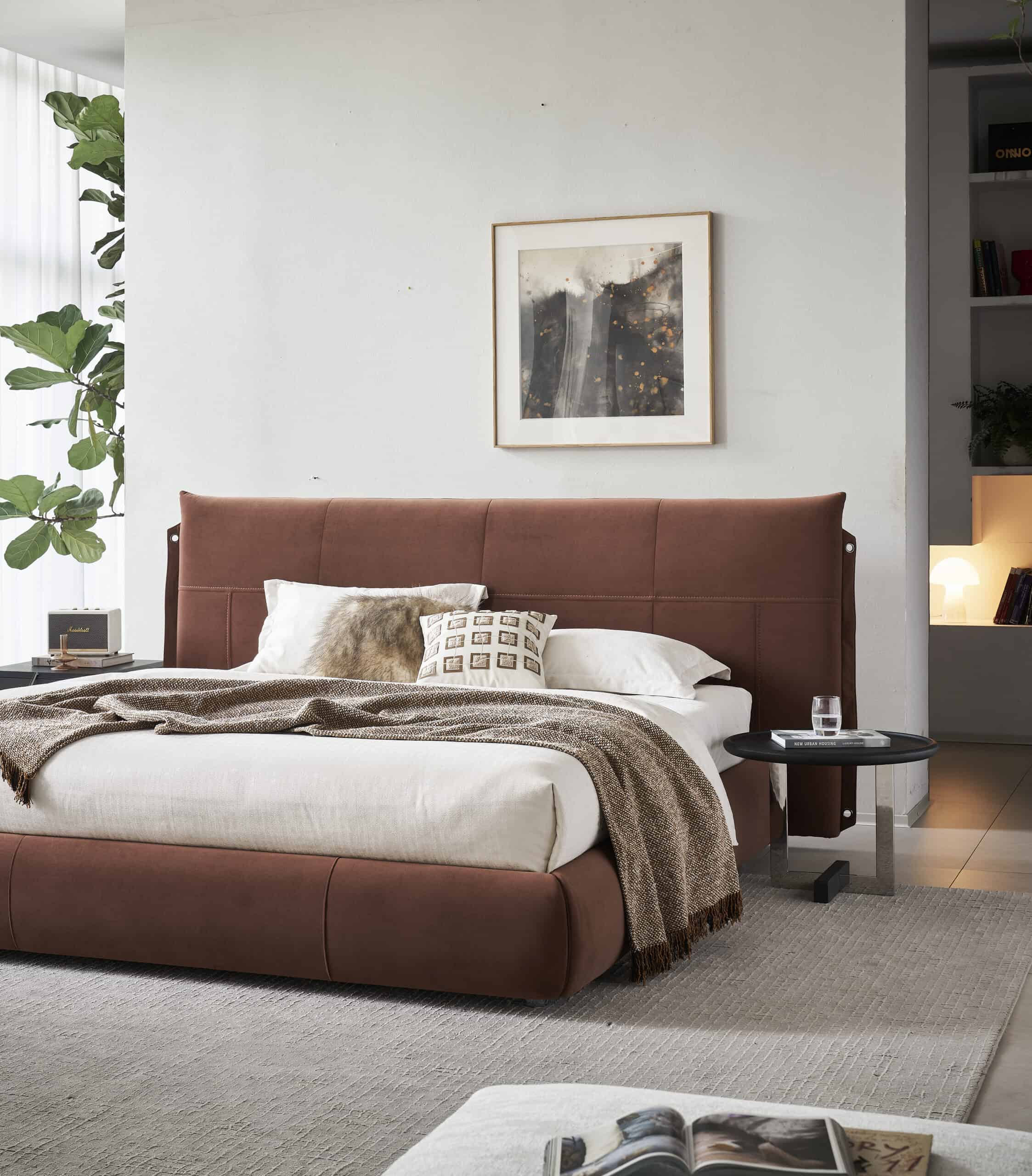 Modern organic bedroom with rust-colored upholstered bed and minimalist decor.