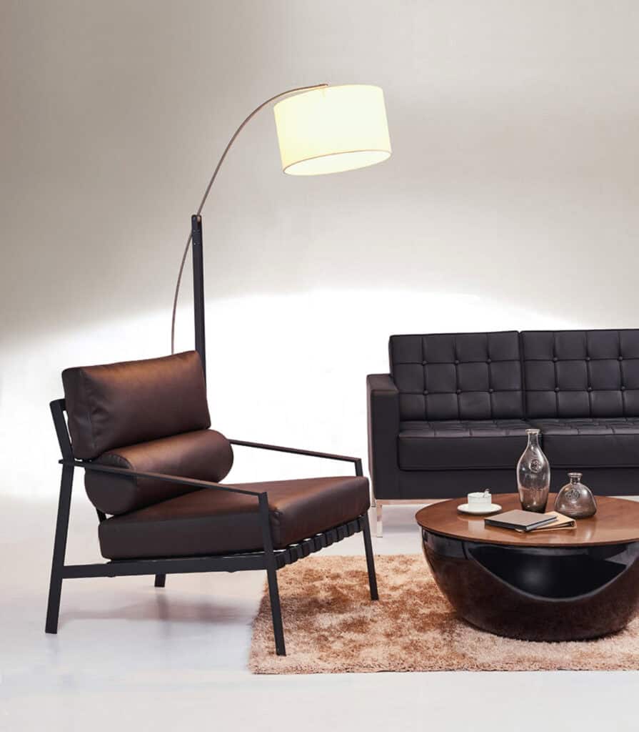 Contemporary living room with black sofa, armchair, and elegant decor for a comfortable home.