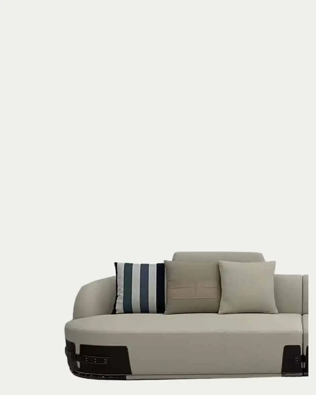 Fendi curved sectional sofa in neutral tones with striped accent pillow.