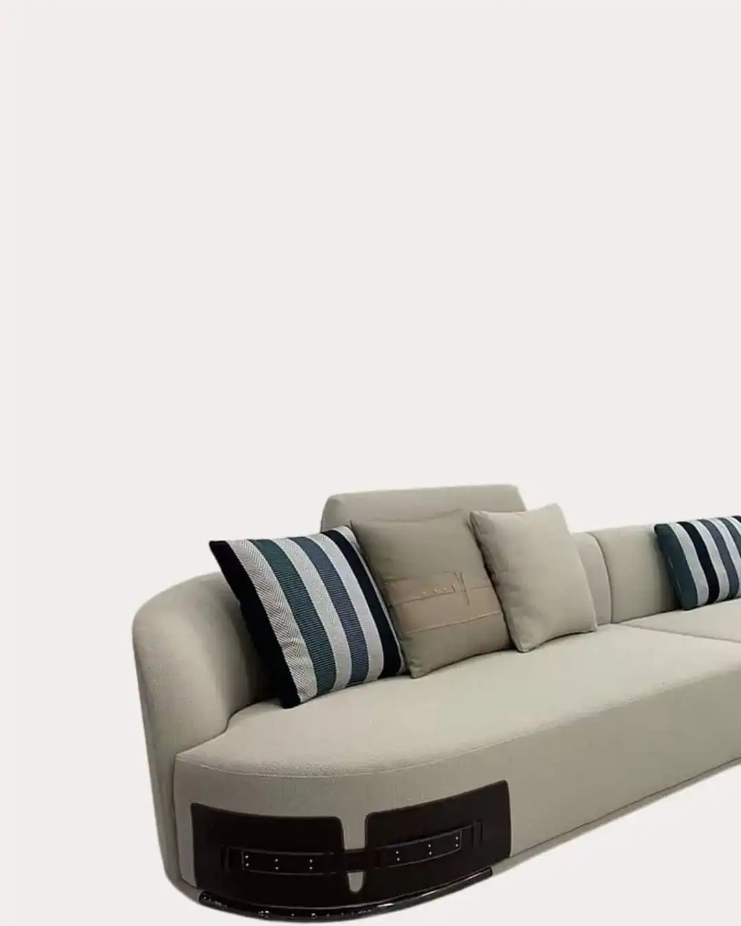 Fendi Curved Sectional Sofa with striped accent pillows, modern and stylish living room furniture.