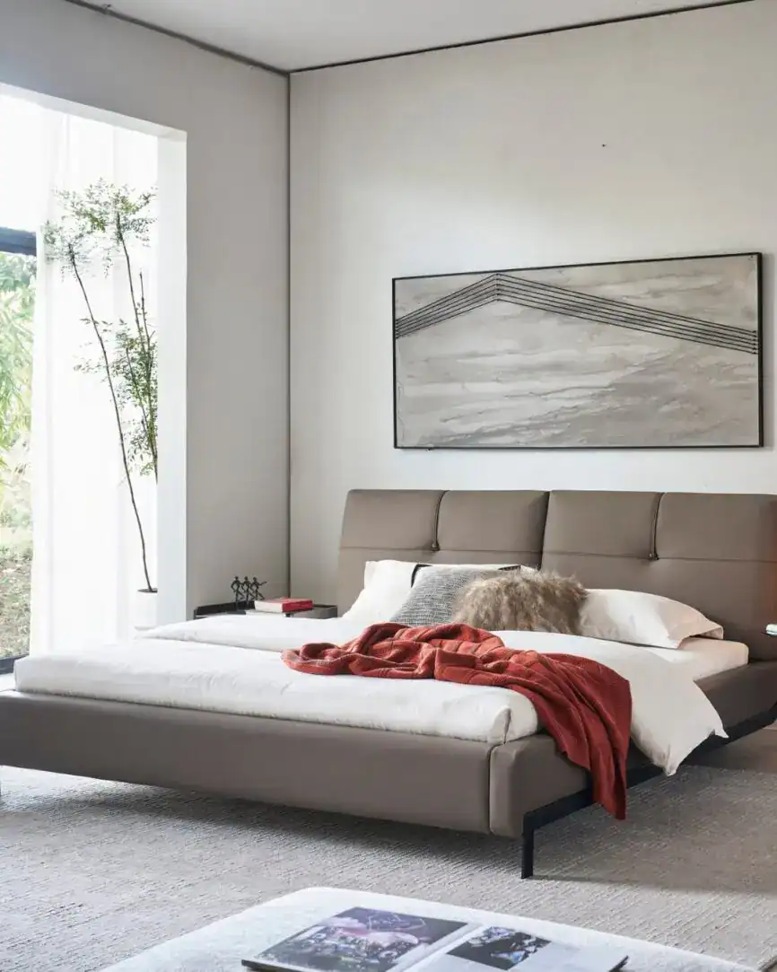 Elegant Dainty Bed with neutral tones and cozy throw blanket in modern bedroom setting.