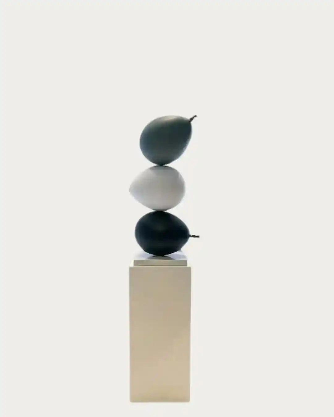 Elegant set of three stacked balloon ornaments in dark shades, perfect for modern holiday decor.
