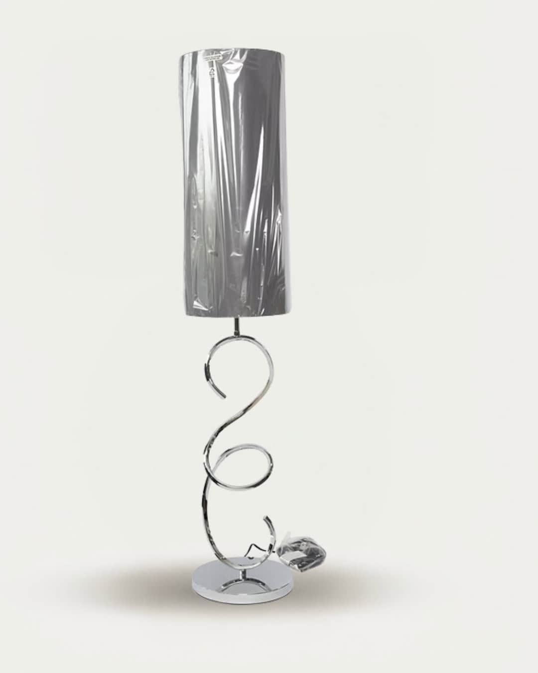 Sculptured spiral floor lamp with metallic finish, modern lighting for contemporary home decor.