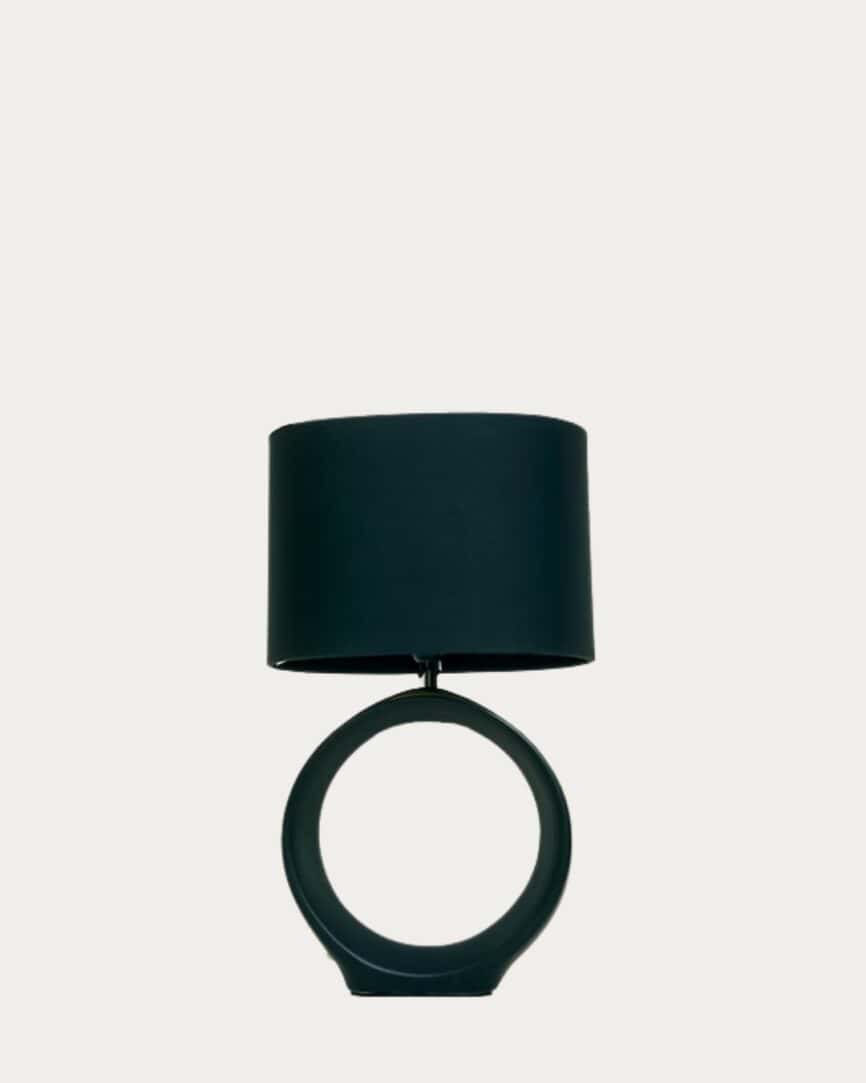 Elegant matte white hollow cream base table lamp with black drum shade for modern home decor.