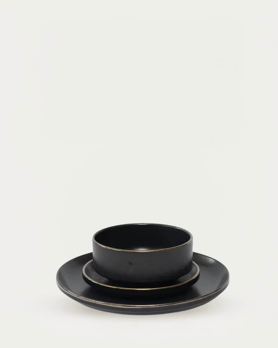 Black Kaiseki stoneware dinner set with matching plates and bowls, elegant and traditional Japanese.