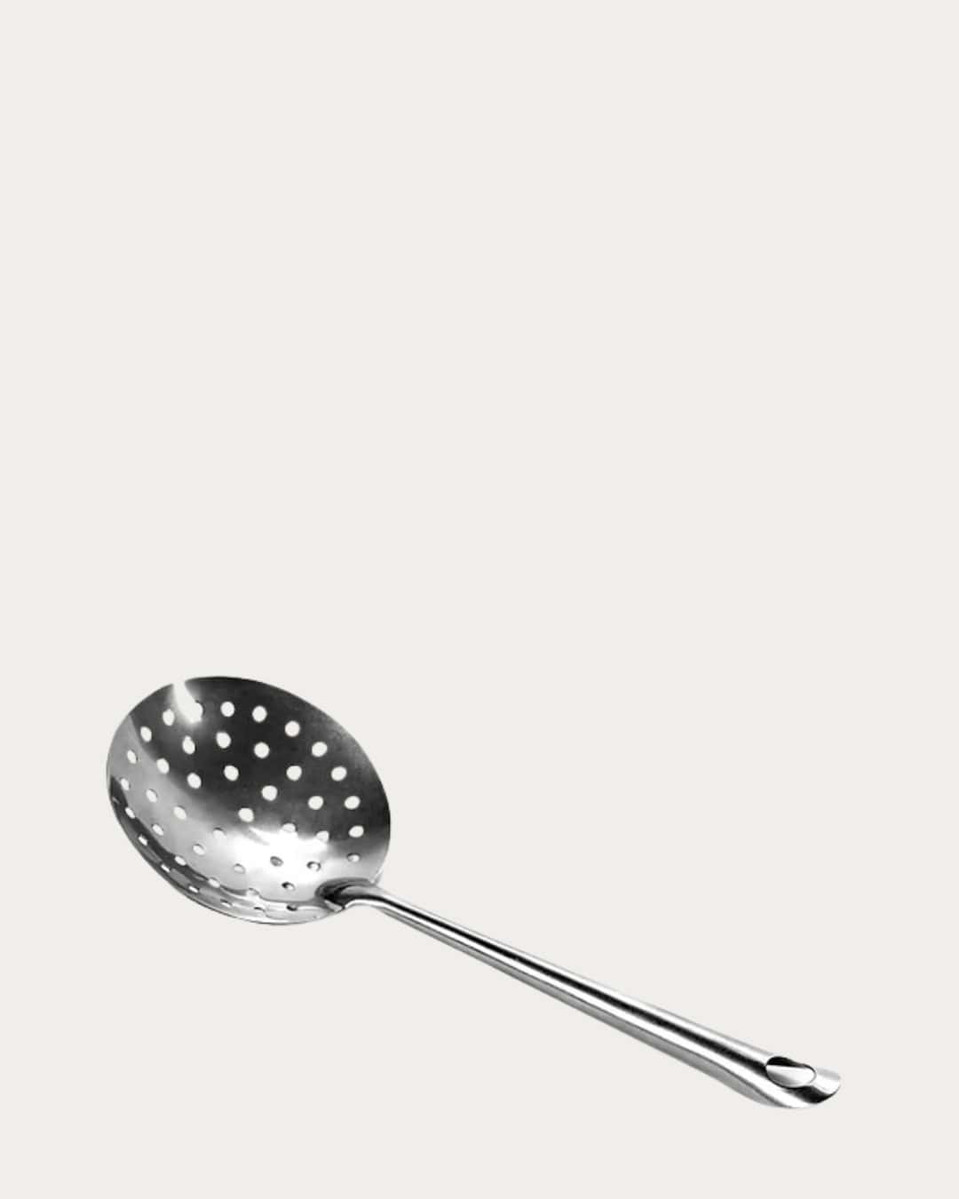 Stainless steel slotted spoon for cooking and serving, durable kitchen utensil.