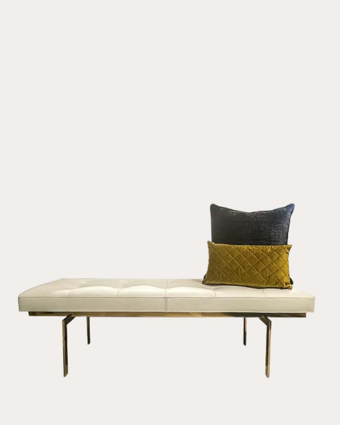 White modern side table with metal legs, styled with decorative pillows, ideal for contemporary livi.