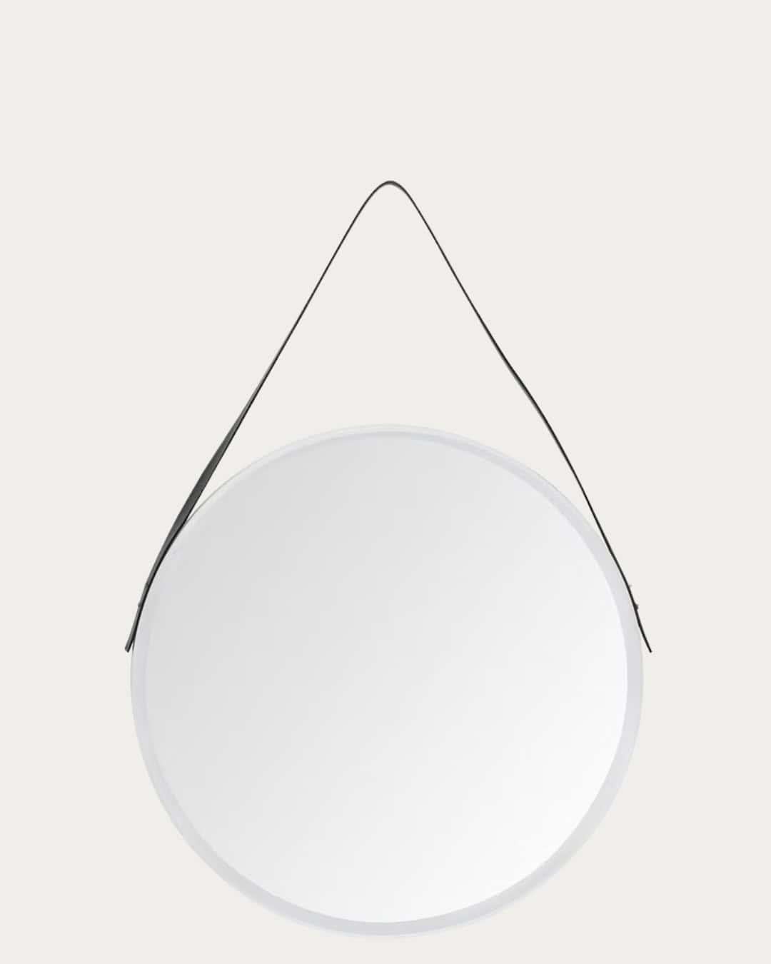 White faux leather round wall mirror with black hanging cord, modern decor accessory.