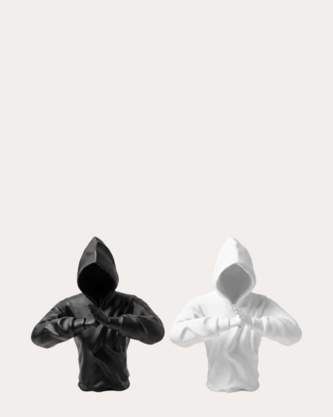 Black and white hooded man with fists raised in a peace or protest gesture.