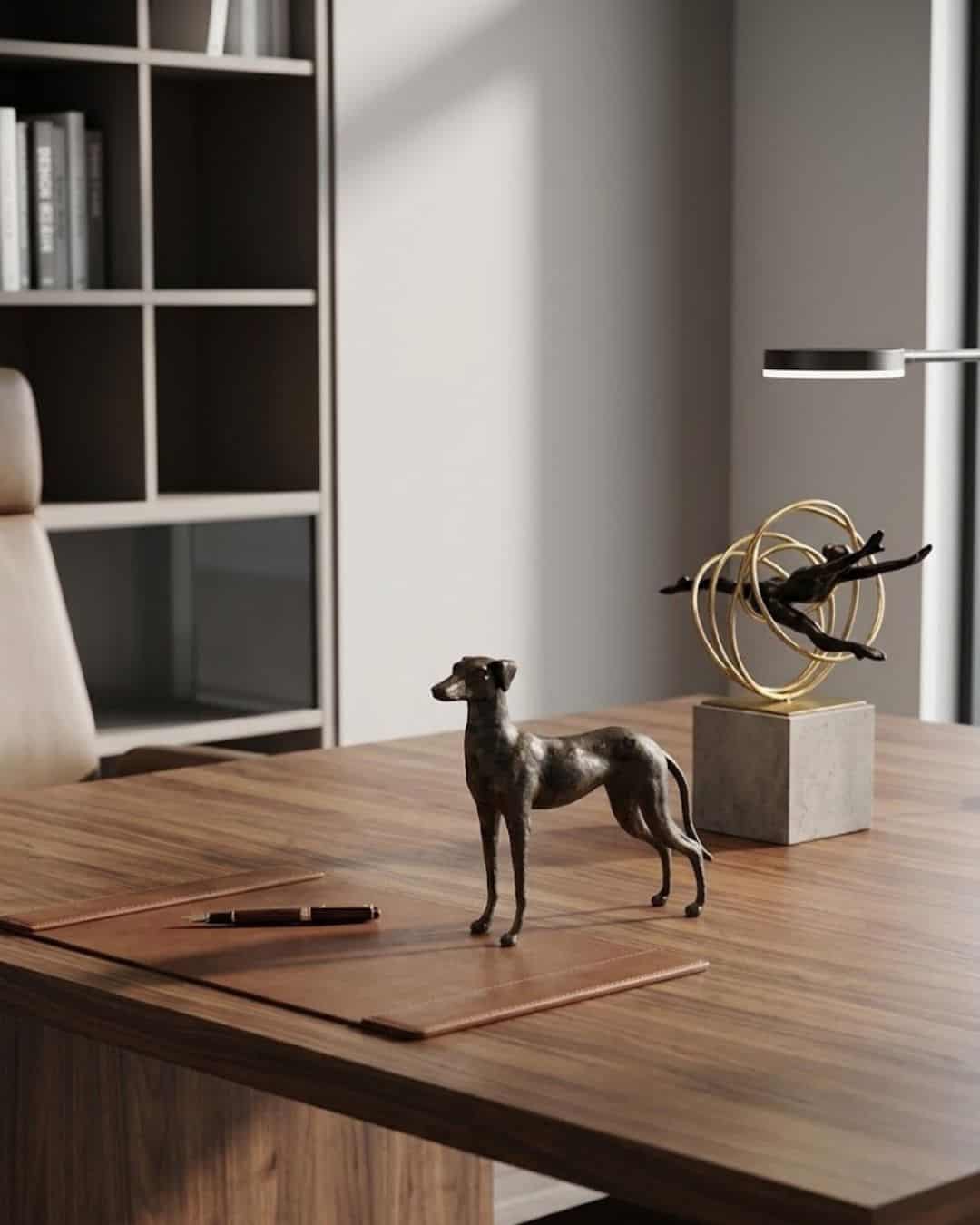 Bronze Looking Back Dog Ornament on a modern wooden desk with decorative sculptures.